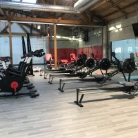 empty workout space with stationary bicycles and row machines